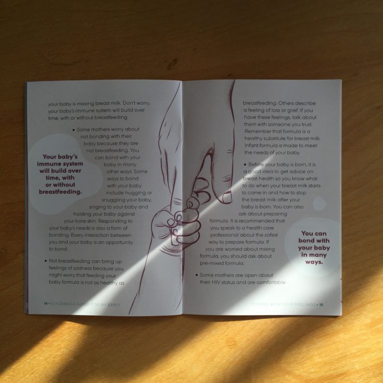 Photo: Two-page spread from “Is Formula Good for my Baby?” — an infant feeding resource for HIV positive mothers. The spread is filled with text on both sides. In the middle of the spread is an illustration of a baby’s hand holding the forefinger of an adult hand. Two spilled milk shapes are on either side of the page spread. Inside the left hand shape the text reads “Your baby’s immune system will build over time, with or without breastfeeding.” Inside the right hand shape the text reads “You can bond with your baby in many ways.”