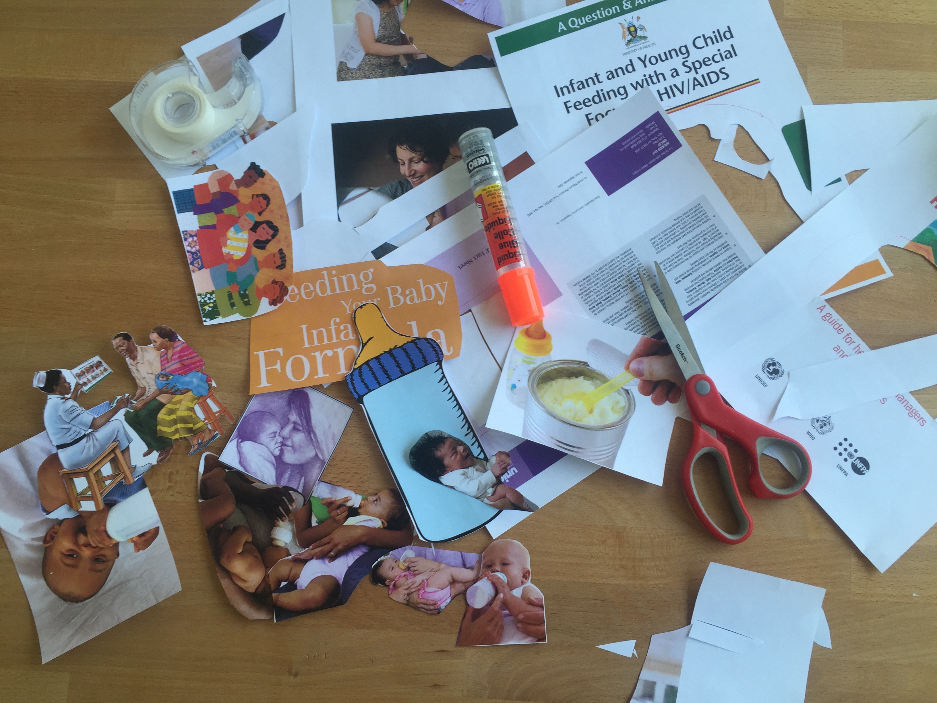 Photo: Collage materials, including glue, tape and scissors as well as cutouts of baby pictures on a desk.