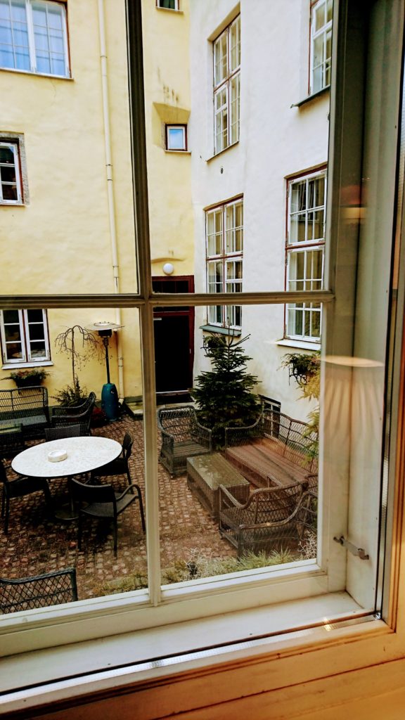 Looking out to a European courtyard like patio from indoors