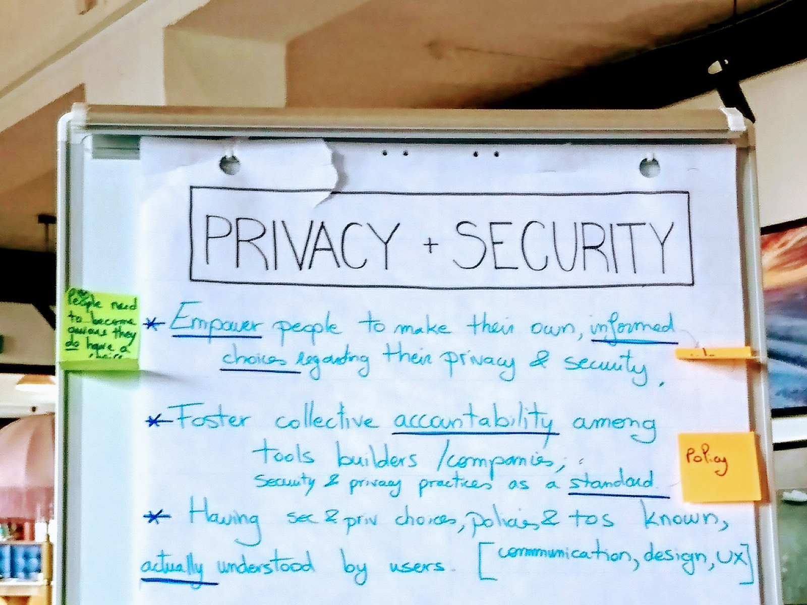 A photograph of part of a newsprint chart. The title reads ‘PRIVACY + SECURITY’, it is written in black and is outlined by a rectangle. There are 3 points written in a bright light blue text with, the keywords are underlined in dark blue.