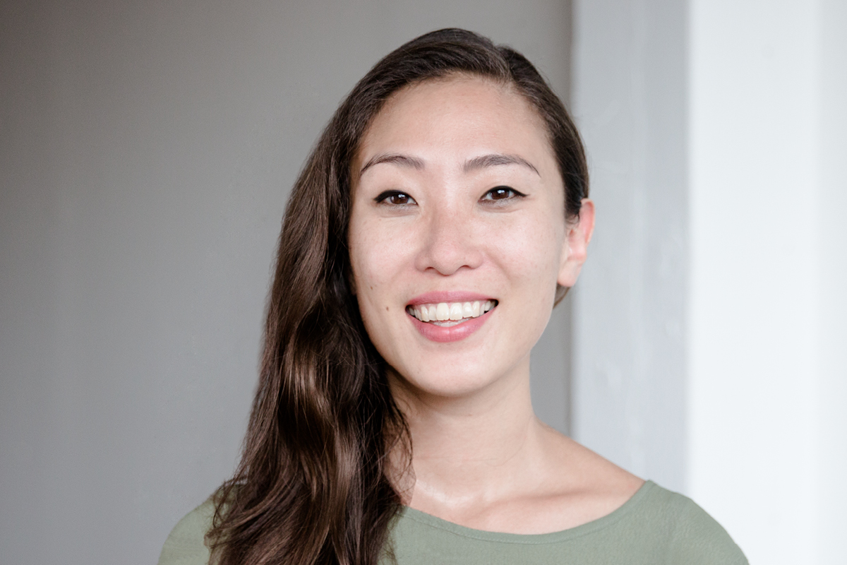 Photo: A headshot of Una Lee, Creative Director at And Also Too. She is smiling and wearing pale green shirt.