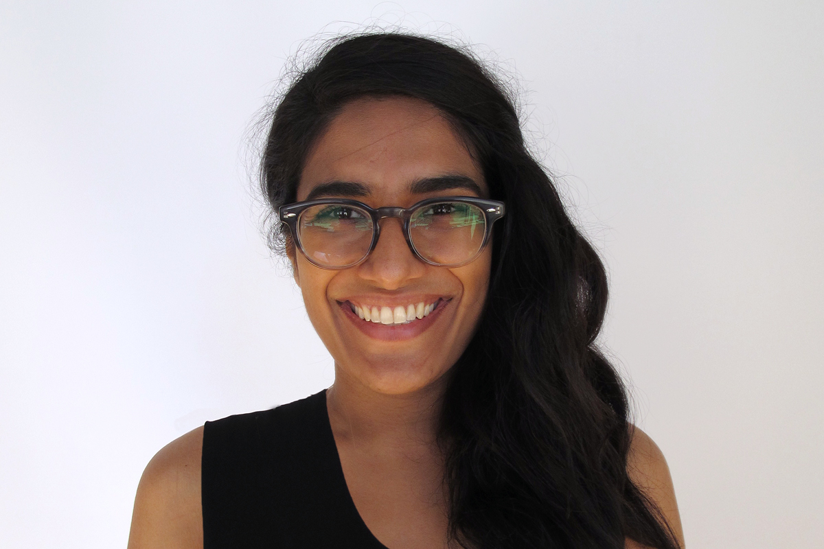 Photo: A headshot of Zahra Agjee, Studio Coordinator at And Also Too. She is smiling and wearing a black shirt.
