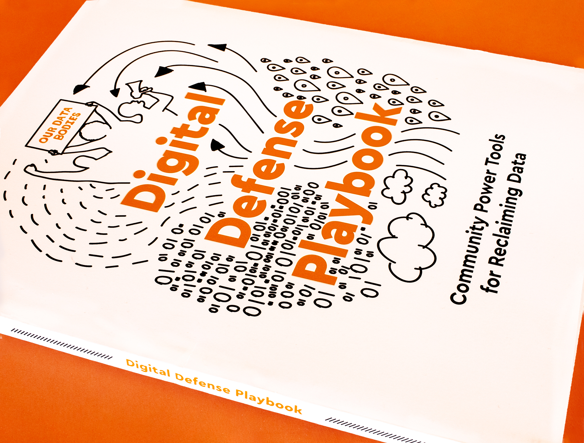 Photo: Front cover of the Digital Defence Playbook: Community Power Tools for Reclaiming Data. Illustration of data, arrows, lines, clouds, flowing upward towards 3 community members holding a sign that says “Our Data Bodies.”